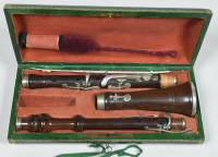 Cocuswood oboe with nine silver keys, on pillars on crescent shaped plates, signed 
